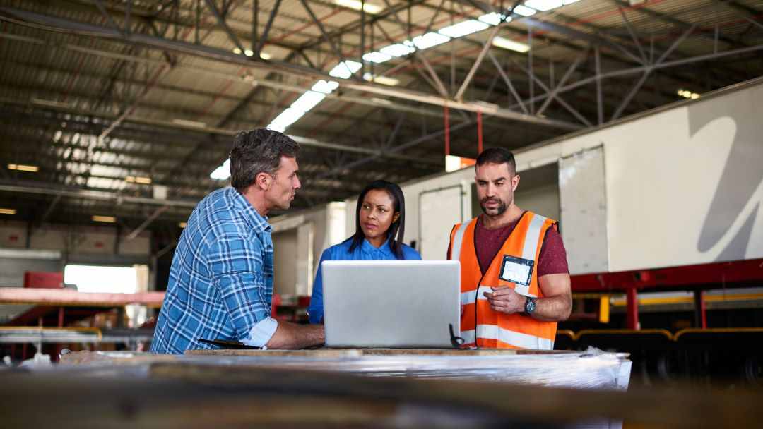 Three warehouse managers talking together