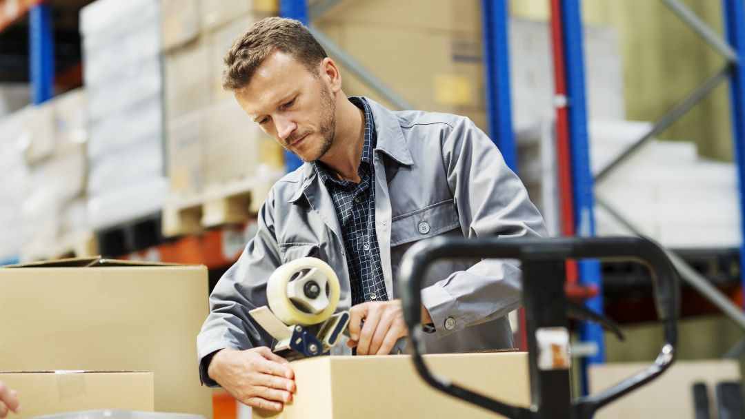warehouse worker taping boxes