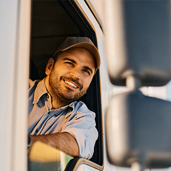 Man driving truck with head out of the window