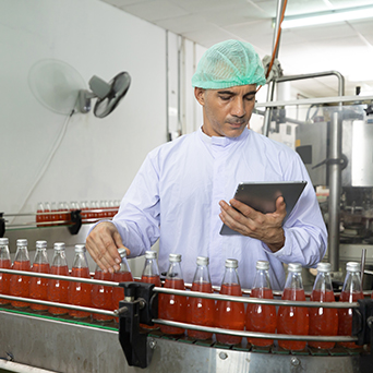 Worker on bottle assembly line